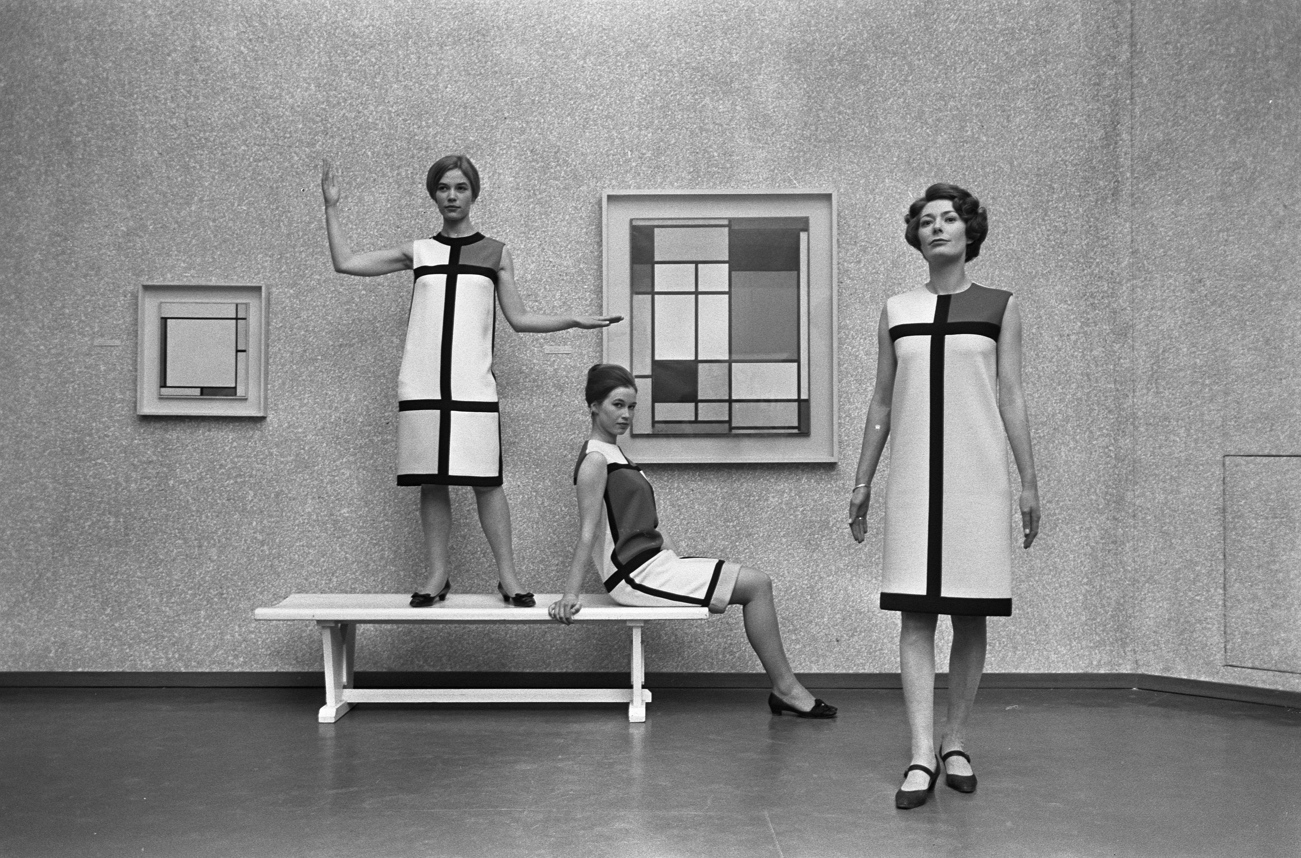 Three models pose in a museum wearing Mondrian-inspired shift dresses