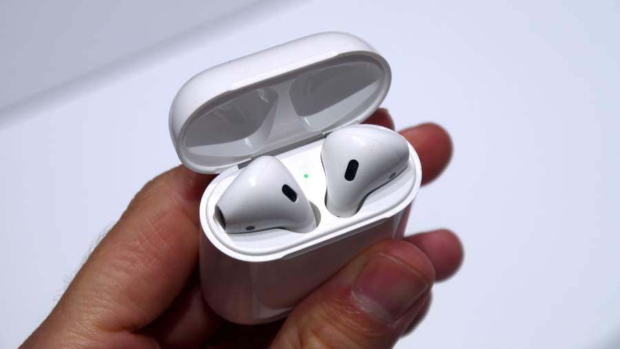 Hand holding a set of Airpods