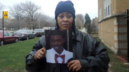 Janet Cooksey holds a photo of her son, Quintonio LeGrier, who was fatally shot by police