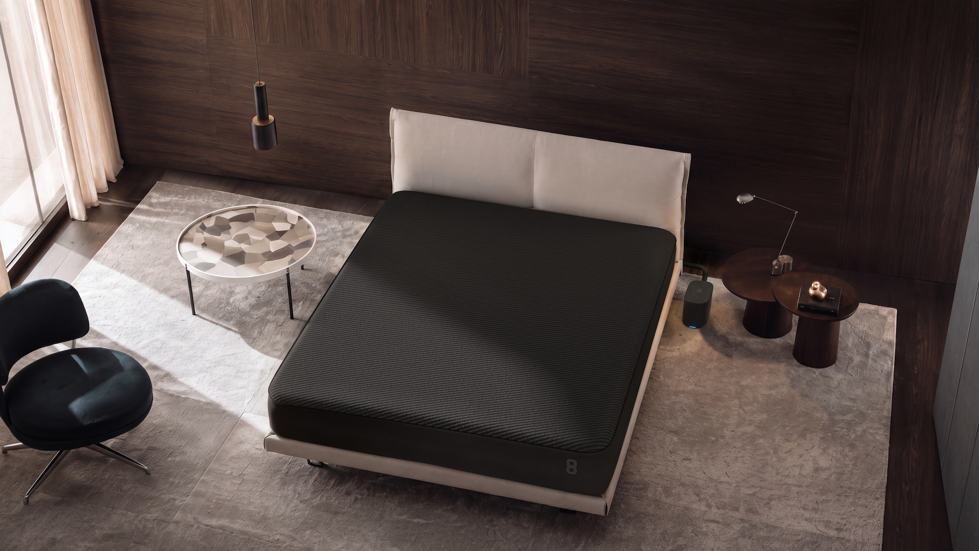 The black smart mattress cover, which is a major part of the new Pod 6, stretched over a mattress in a luxury bedroom