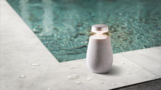 The LG XO2 portable speaker next to a pool