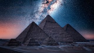The Pyramids of Giza, seen here at night with the Milky Way in the background.