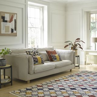 A neutral upholstered sofa in a light-filled living room