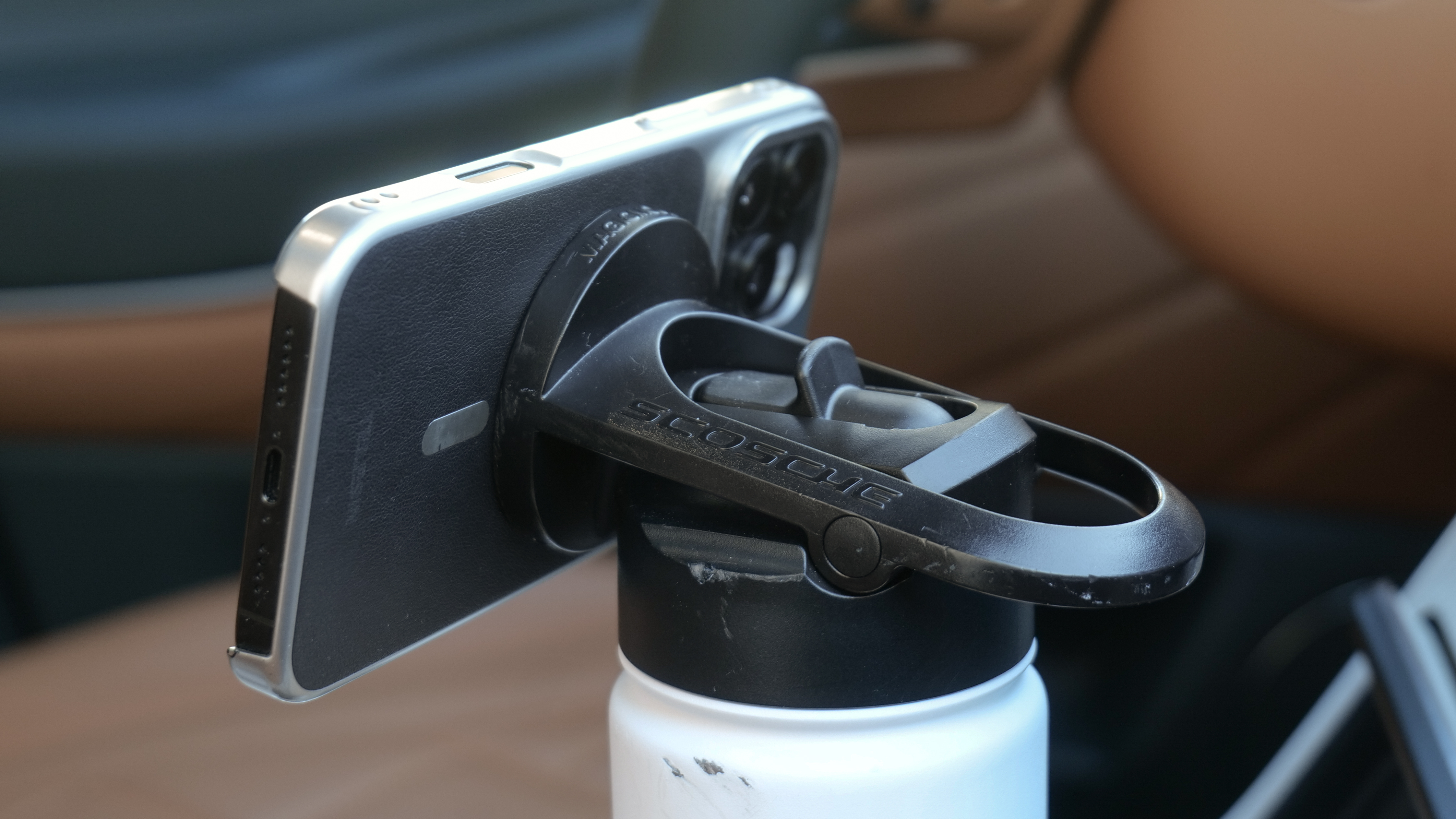 Scosche MagicMount Flask used in car cup holder with iPhone connected to it via MagSafe.