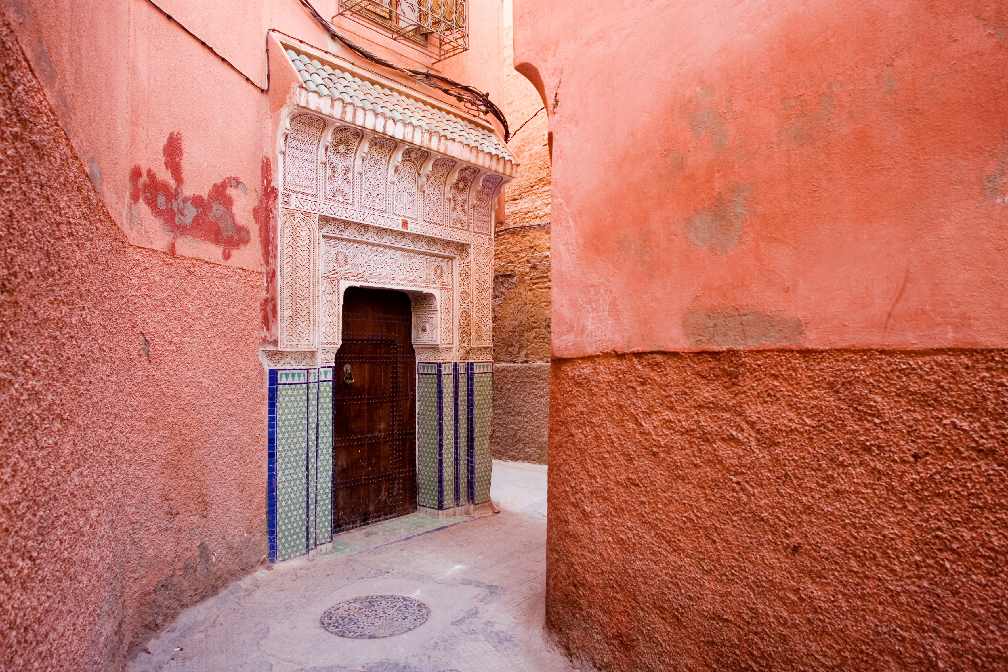Wooden doorway with carved stone surround in the Marrakech Medina