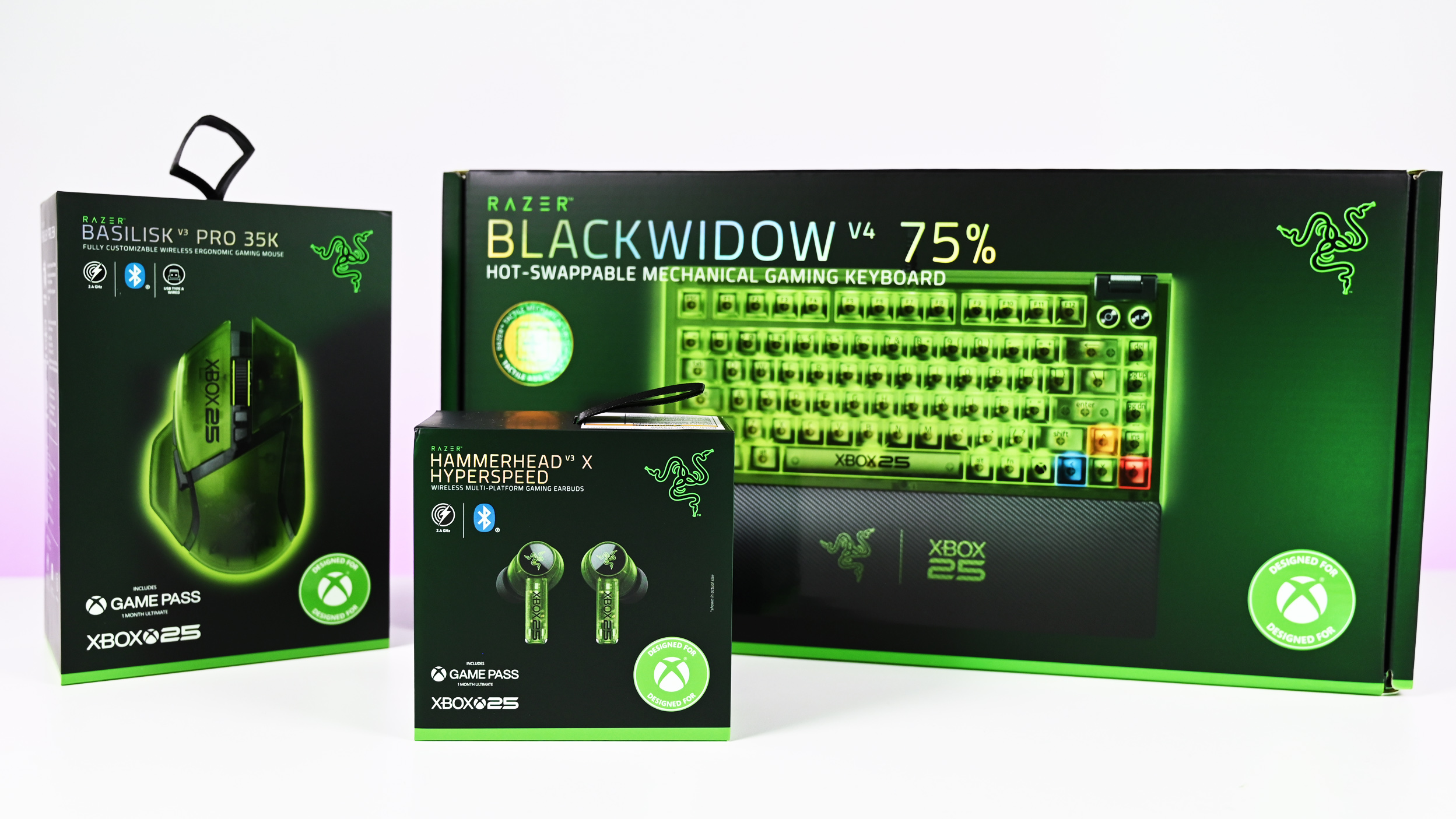 Retail boxes for the Razer Xbox 25th Anniversary Collection: Basilisk V3 Pro 35K mouse, Hammerhead V3 X earbuds, and BlackWidow V4 75% keyboard.