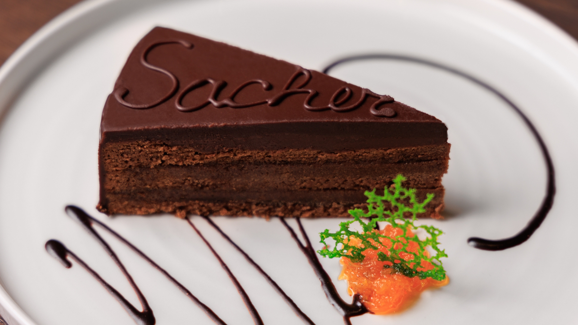 A slice of Sachertorte on a white plate