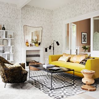Grey living room with yellow sofa and brown chair