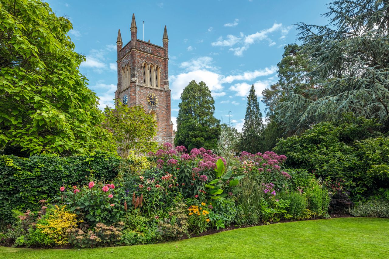 The garden and church are inextricably linked by their proximity.