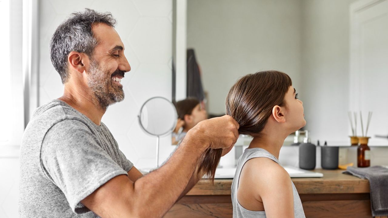 father doing daughters hair