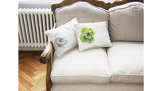 room with wooden flooring white cushion and sofa