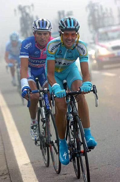 Helmet straps flapping Klodie hammers up the climb with Bruseghin