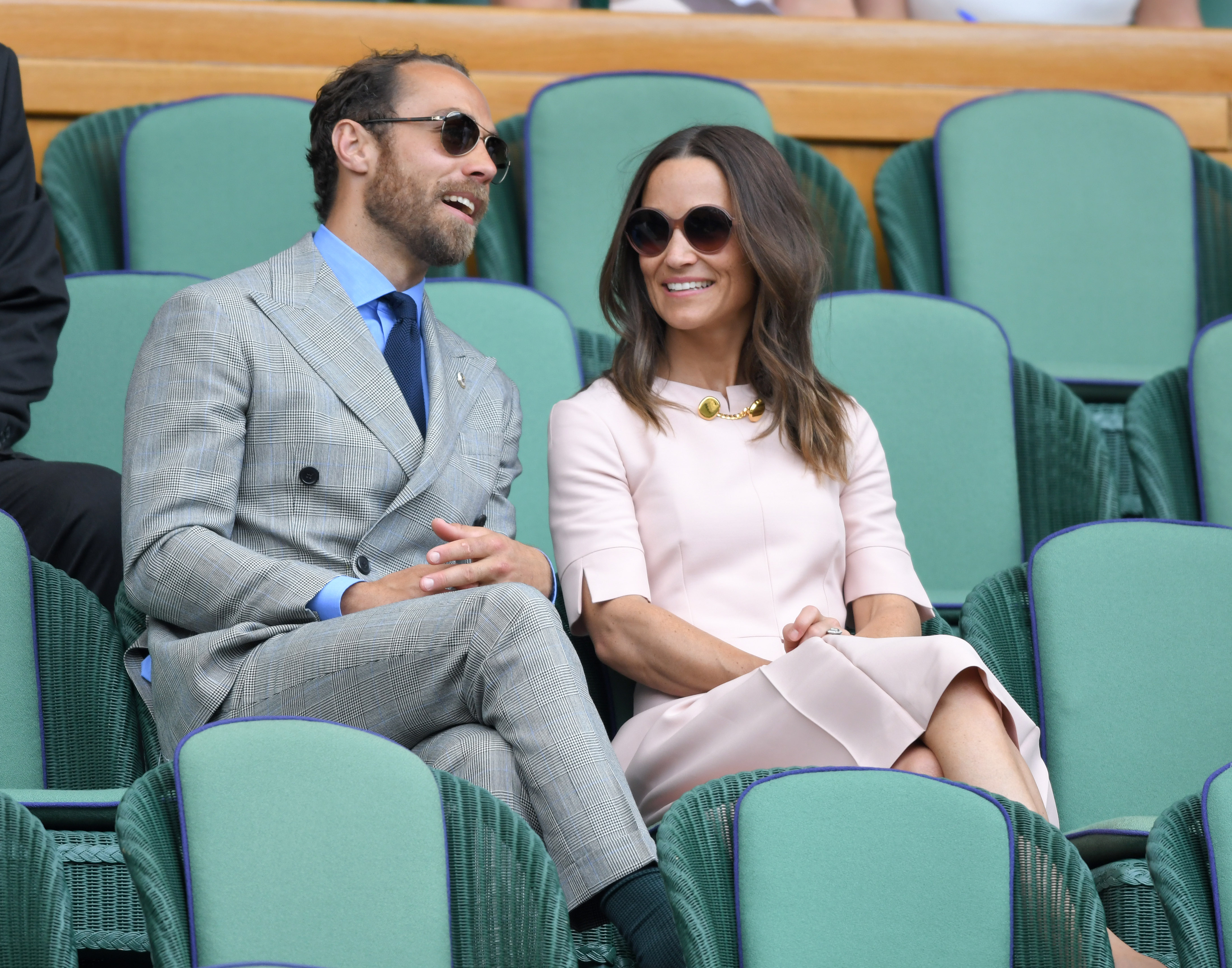 James and Pippa Middleton sitting in green chairs at Wimbledon