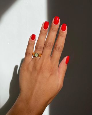 woman wearing Red nail polish