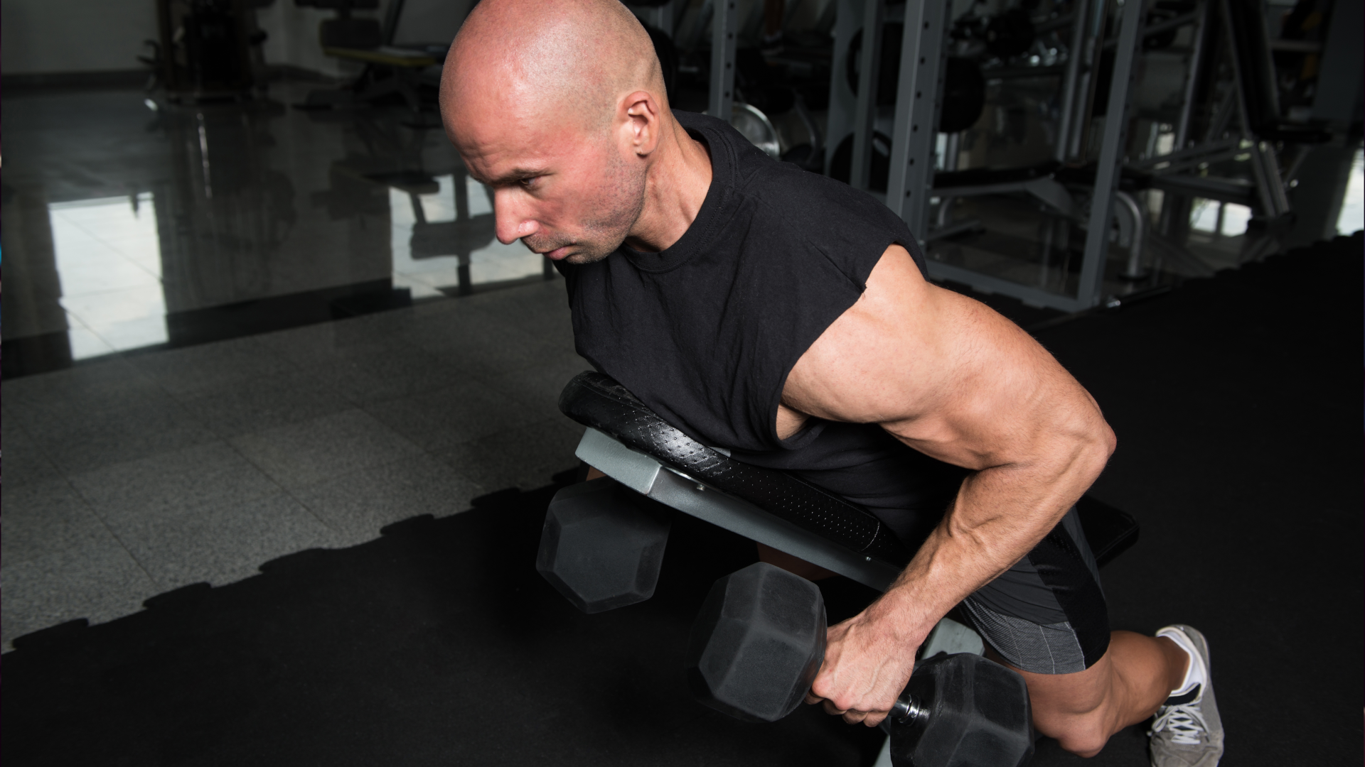 A man performing chest supported dumbbell rows