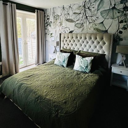 green bedroom with floral wallpaper