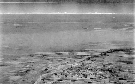 black and white aerial photo showing Earth's horizon