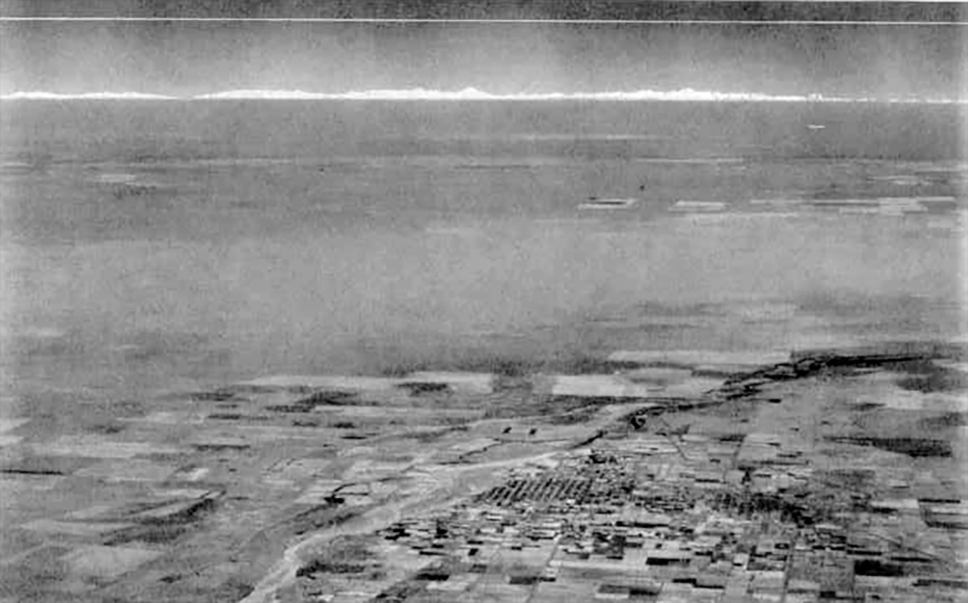 black and white aerial photo showing Earth's horizon