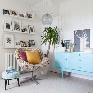 room with white wall and frames
