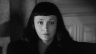 A gloomy Jacqueline speaking to Mary in The Seventh Victim.