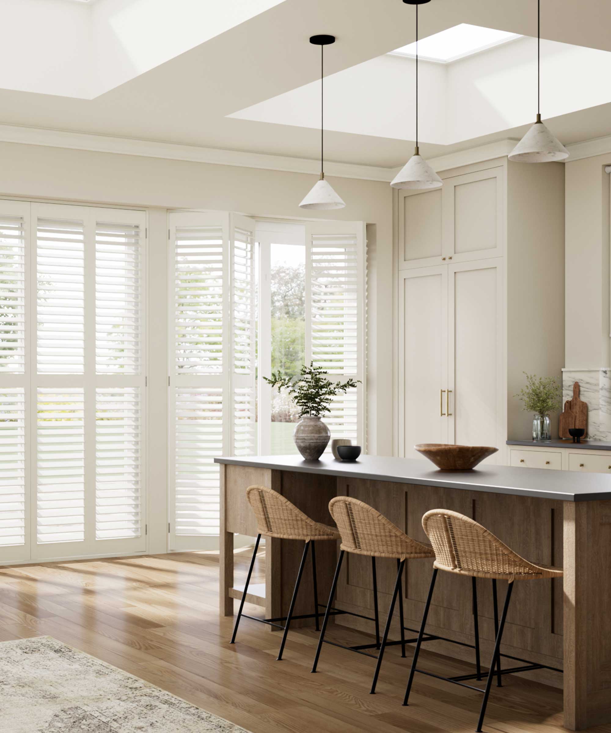 modern kitchen space with a large island, rooflights overhead and white shutters across the full-height rear glazing