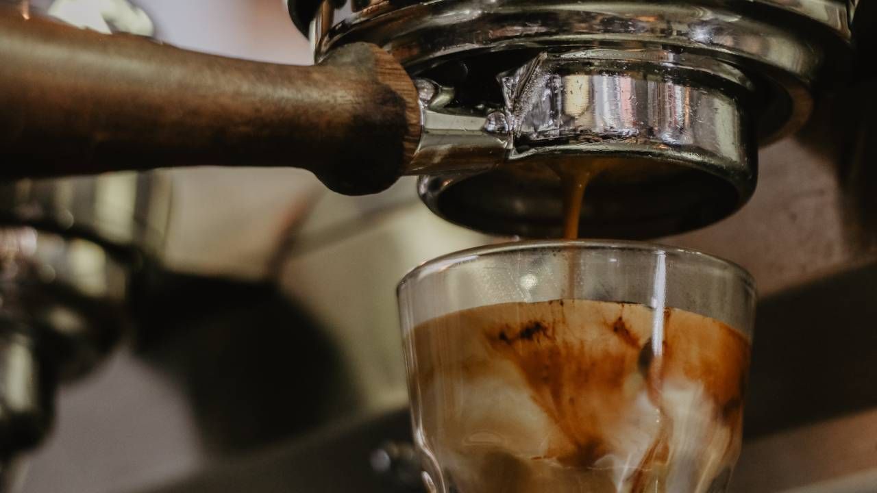 Bean to cup coffee machine pouring into a glass mug