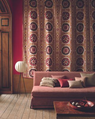 Boho-style room with warm colored sofa