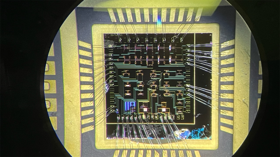 A wire-bonded die consisting of over 20 gallium nitride high-electron mobility transistors, seen here under a microscope, could be used in nuclear sensing equipment because of its high resistance to radiation