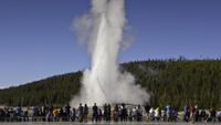 Visitors watching eruption of Old Faithful at Yellowstone National Park