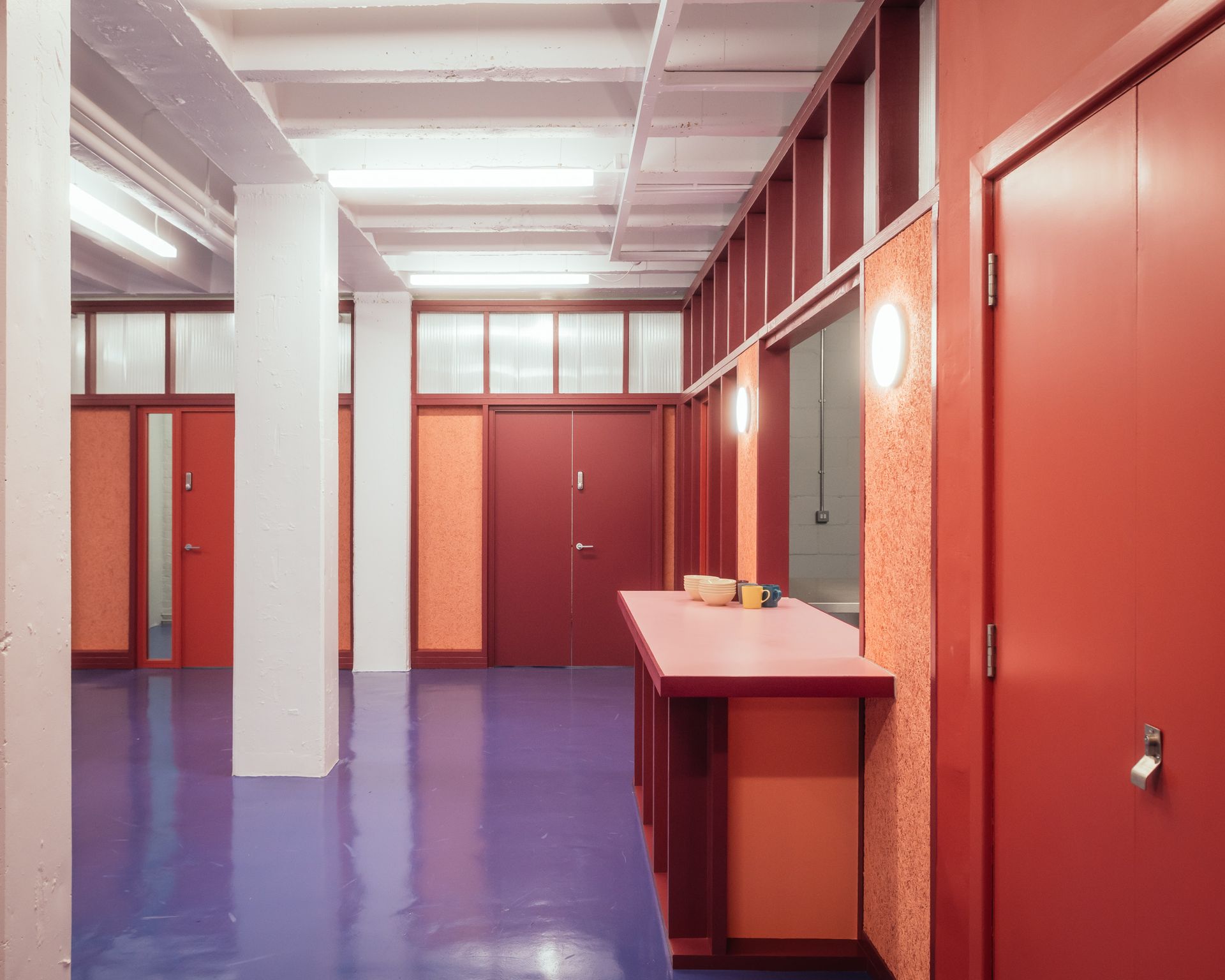 The Common Rooms interior with red walls and features