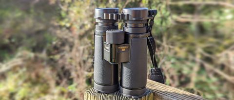Nikon Monarch HG 10x42 binoculars placed on a fence post