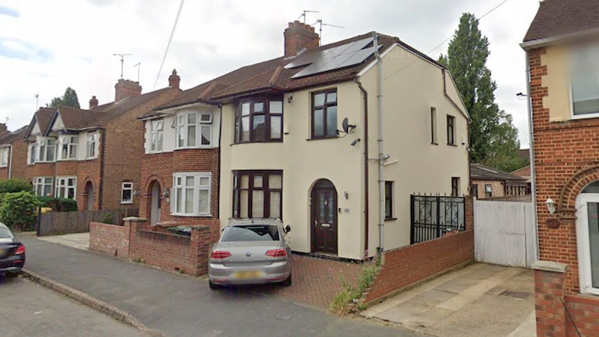 A white walled home with extensions in the back garden and solar panels installed onto the roof