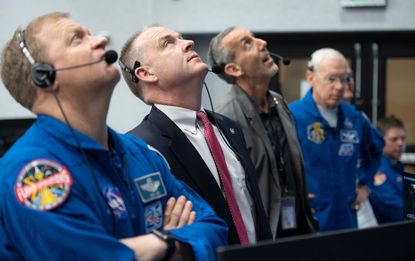 NASA astronaut Eric Boe, assistant to the chief of the astronaut office for commercial crew, left, and Norm Knight, deputy director of flight operations at NASA's Johnson Space Center watch t