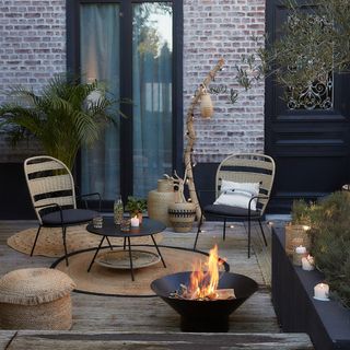 outdoor fire pit with rugs and rattan garden furniture