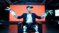 A man with prosthetic limbs on a TED Talk stage