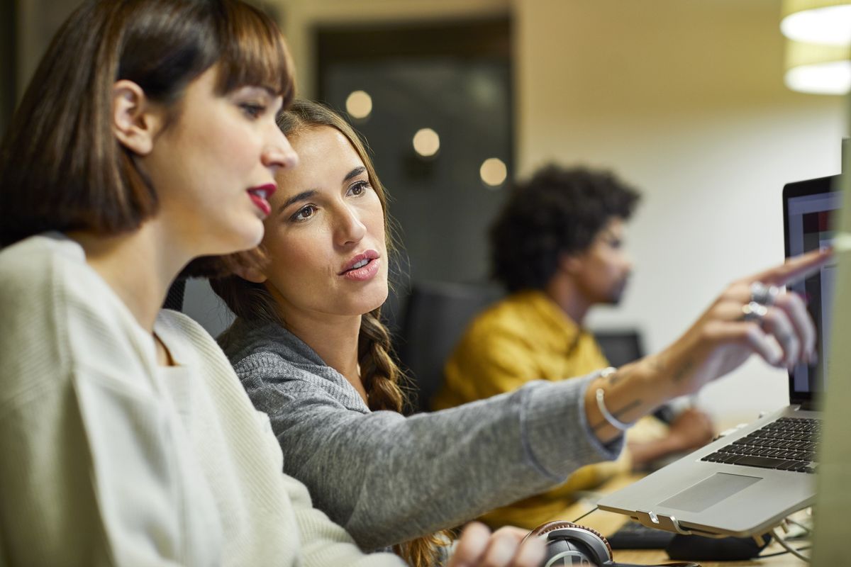 Two women looking at a computer monitor