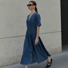 woman wearing a denim dress from the M&S new in section