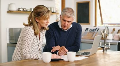 Couple looking at a computer screen and documents