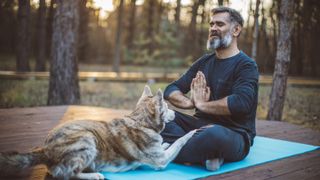 Man meditating with dog