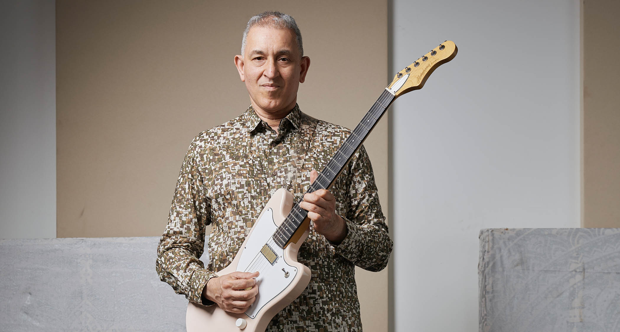 Aziz Ibrahim is photographed at home with some of his favourite guitars