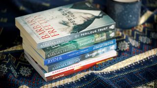 A stack of books on a rug