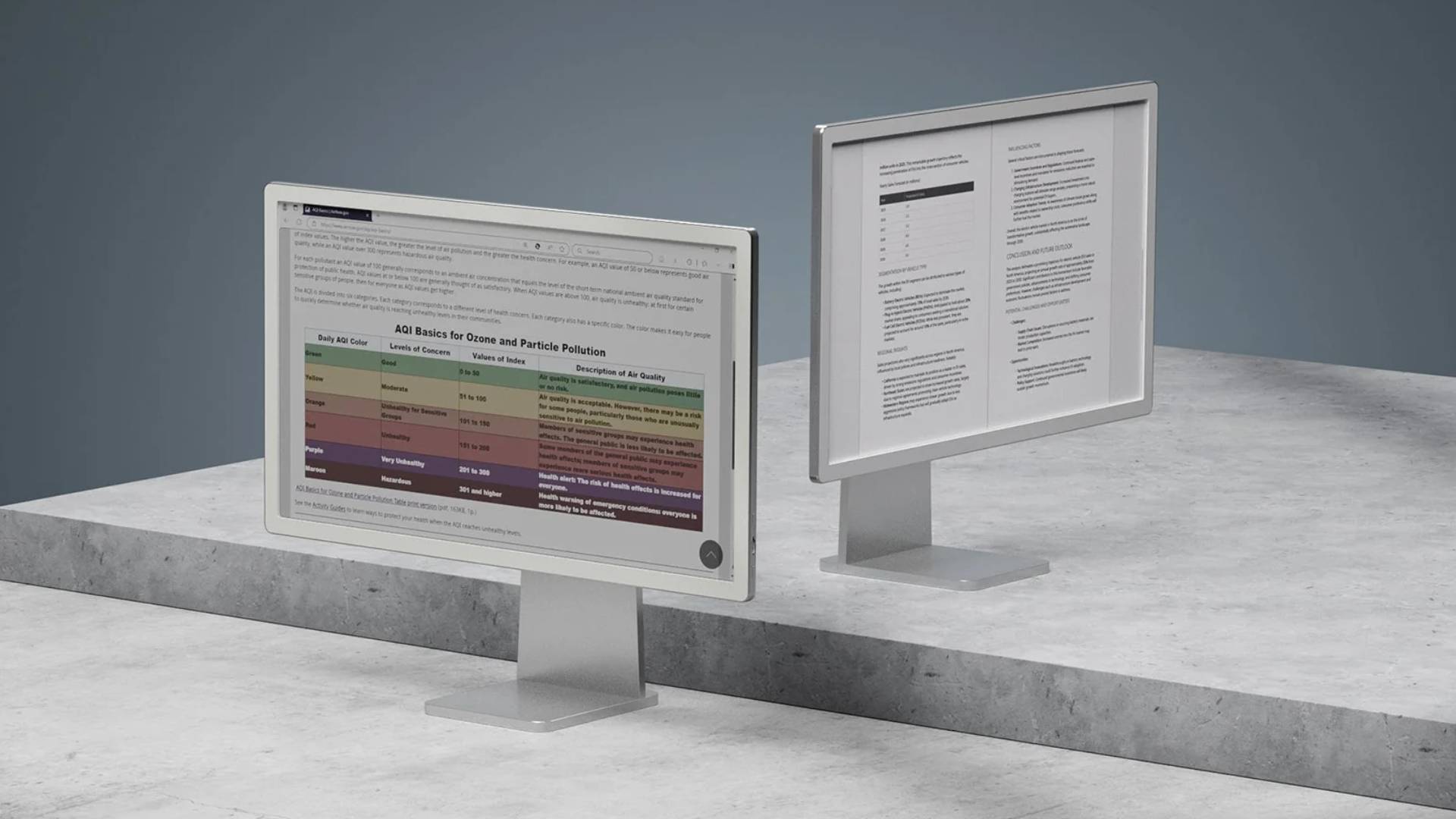 BOOX&#039;s Mira Pro--the color version and the greyscale version of the e-ink monitor--sit side by side on a marble counter.