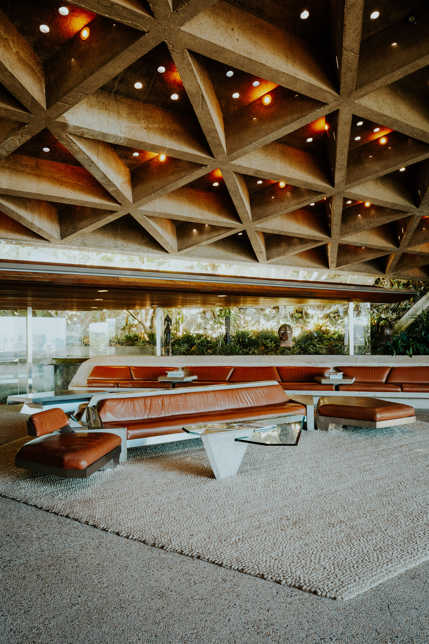 Sheats-Goldstein Residence in LA with its concrete sloped roof, pool and green open grounds