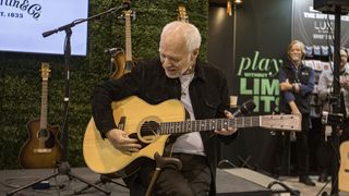 Peter Frampton admires a Martin guitar gifted to him by C.F. Martin & Co. during Global Media Day at The 2025 NAMM Show at Anaheim Convention Center on January 22, 2025 in Anaheim, California