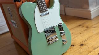 A Fender Player II Telecaster leaning against an Orange guitar amplifier