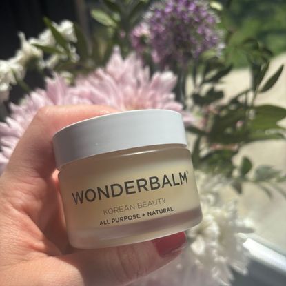 a hand holding wonderbalm