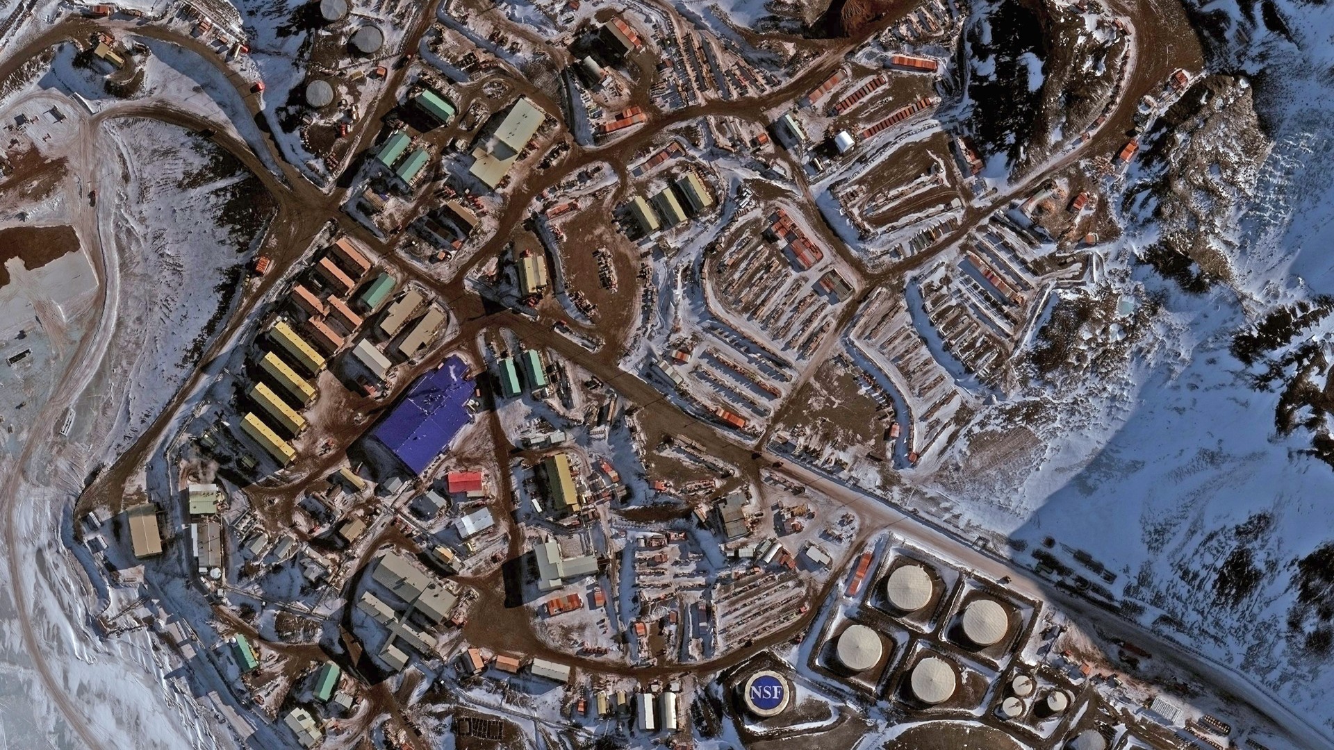 an overhead view of a series of buildings on a snowy landscape
