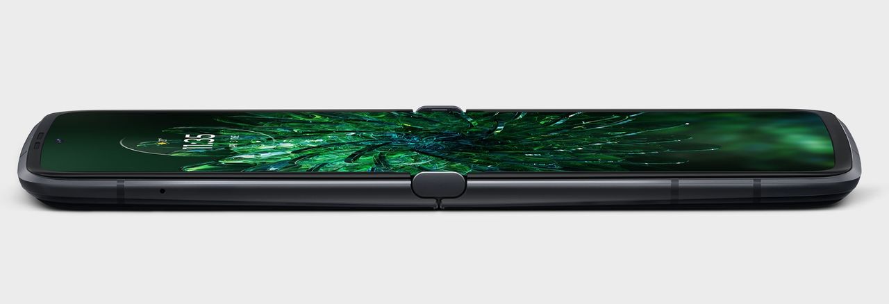 The Motorola Razr 2022 lying flat and open with a green wallpaper
