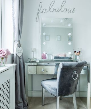 dressing room with grey chair and curtains
