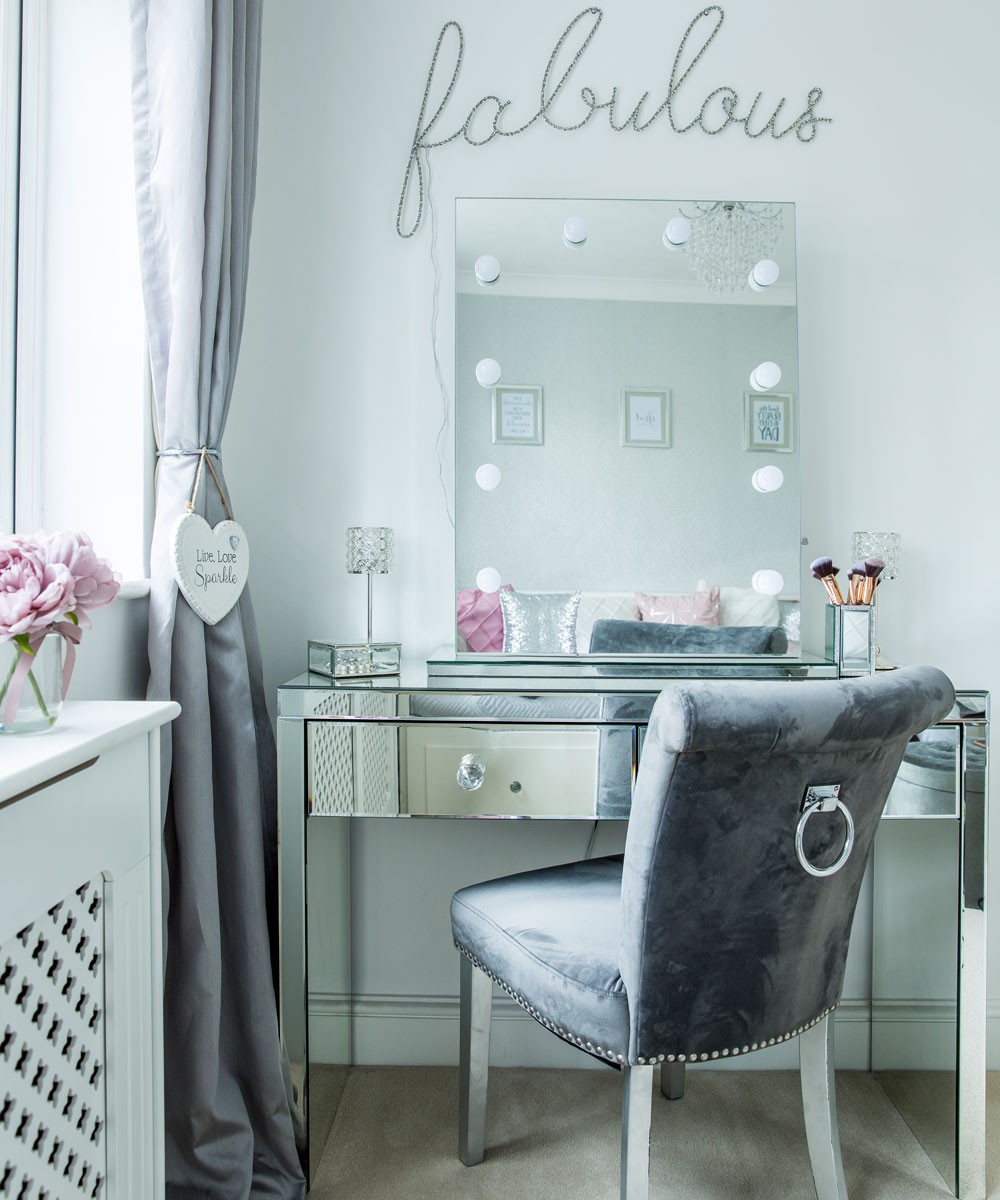 dressing room with grey chair and curtains